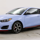 A photo of a blue Hyundai Veloster N hatchback.